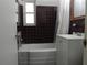 Bathroom with a bath tub, sink, and window at 10308 Fore Dr, Tampa, FL 33612