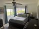 Bright bedroom with a large window, ceiling fan, and comfortable furnishings for a relaxing retreat at 10308 Fore Dr, Tampa, FL 33612
