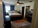 Inviting bedroom with a ceiling fan, plush rug, and a closet for ample storage at 10308 Fore Dr, Tampa, FL 33612