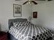 Cozy bedroom featuring a patterned comforter, upholstered headboard, and stylish decor at 10308 Fore Dr, Tampa, FL 33612