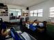 Bright bonus room featuring sliding glass doors and organized built-in shelving for storage at 10308 Fore Dr, Tampa, FL 33612
