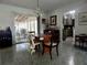 A dining room that looks into the kitchen and the porch at 10308 Fore Dr, Tampa, FL 33612