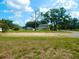 Spacious front yard view of a two-story home with a light-colored exterior and a visible two-car garage at 10308 Fore Dr, Tampa, FL 33612