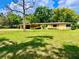 Charming single-story home features a well-manicured front yard with mature landscaping and a covered front porch at 10308 Fore Dr, Tampa, FL 33612