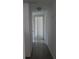 Neutral hallway with doors leading to various rooms, offering easy access and flow throughout the home at 10308 Fore Dr, Tampa, FL 33612
