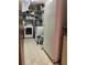 Practical laundry room with tiled floor, washer, dryer, and an additional refrigerator for convenience at 10308 Fore Dr, Tampa, FL 33612
