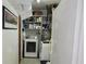 Functional laundry area with a washing machine, dryer, and storage shelves for supplies at 10308 Fore Dr, Tampa, FL 33612