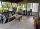 Inviting screened porch featuring wicker furniture, providing an ideal spot for outdoor relaxation at 10308 Fore Dr, Tampa, FL 33612