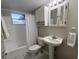 Cozy bathroom with a pedestal sink, window, cabinet and combination tub and shower with curtain at 10367 109Th Ave, Largo, FL 33773