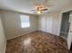 Comfortable bedroom featuring a window, ceiling fan, spacious closet and unique tile-patterned flooring at 10367 109Th Ave, Largo, FL 33773