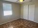 Comfortable bedroom featuring a window, ceiling fan, spacious closet and unique tile-patterned flooring at 10367 109Th Ave, Largo, FL 33773
