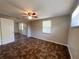 Comfortable bedroom featuring a window, ceiling fan, spacious closet and unique tile-patterned flooring at 10367 109Th Ave, Largo, FL 33773