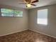 Bright bedroom featuring multiple windows, a ceiling fan, and unique tile-patterned flooring at 10367 109Th Ave, Largo, FL 33773