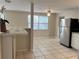 The eat-in kitchen has a center counter, tiled floors, and a stainless steel refrigerator at 10367 109Th Ave, Largo, FL 33773