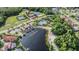 Aerial view highlighting tennis courts, community pool, clubhouse, dock, and waterfront access at 10641 Cory Lake Dr, Tampa, FL 33647