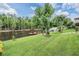 The landscaped back yard overlooks a beautiful lake with a private dock at 10641 Cory Lake Dr, Tampa, FL 33647