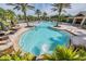 Community pool features a large pool deck, tropical landscaping, and comfortable lounge seating at 10641 Cory Lake Dr, Tampa, FL 33647