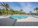 Large community pool with multiple swimming areas, palm trees, lounge chairs and spacious pool deck at 10641 Cory Lake Dr, Tampa, FL 33647