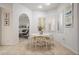 Bright dining area featuring a modern round table and view into the adjoining living room at 10641 Cory Lake Dr, Tampa, FL 33647