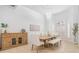 Bright dining room featuring a wooden table, cushioned chairs, and stylish light fixture, perfect for gatherings at 10641 Cory Lake Dr, Tampa, FL 33647