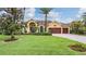 Lovely yellow home with a 3-car garage and beautiful landscaping at 10641 Cory Lake Dr, Tampa, FL 33647