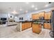 Spacious open concept kitchen with stainless steel appliances, wood cabinets, and an island at 10641 Cory Lake Dr, Tampa, FL 33647