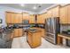 Bright kitchen with stainless steel appliances, wood cabinets, tile floor, and granite countertops at 10641 Cory Lake Dr, Tampa, FL 33647