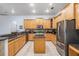 Spacious kitchen featuring wood cabinets, stainless steel appliances, and granite countertops at 10641 Cory Lake Dr, Tampa, FL 33647