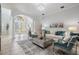 Welcoming living room with comfortable seating, a decorative rug, and elegant glass front doors at 10641 Cory Lake Dr, Tampa, FL 33647