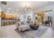 Open living area featuring a sectional sofa, kitchen with bar seating, and access to the patio at 10641 Cory Lake Dr, Tampa, FL 33647