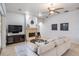 Bright living room featuring a fireplace, ceiling fan, and comfortable neutral furnishings at 10641 Cory Lake Dr, Tampa, FL 33647