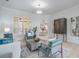 Inviting living room featuring stylish seating, large windows with shutters, and views to the dining area at 10641 Cory Lake Dr, Tampa, FL 33647