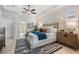 Spacious main bedroom with a tray ceiling, comfortable bed, and view to the ensuite bathroom at 10641 Cory Lake Dr, Tampa, FL 33647