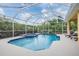 This beautiful screened-in pool is surrounded by mature landscaping for extra privacy at 10641 Cory Lake Dr, Tampa, FL 33647