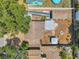 Aerial view of the home showcasing the backyard with a fire pit and a detached garage at 1117 Tyrone N Blvd, St Petersburg, FL 33710