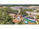 Overhead view of the neighborhood and home's layout featuring a spacious backyard and mature trees at 1117 Tyrone N Blvd, St Petersburg, FL 33710