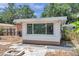 The backyard features a small patio area, a fire pit, and a room addition with large windows at 1117 Tyrone N Blvd, St Petersburg, FL 33710