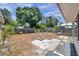 Large backyard featuring a stone fire pit, gazebo, mature trees, and a mix of sunny and shaded areas at 1117 Tyrone N Blvd, St Petersburg, FL 33710
