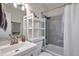 Bright bathroom featuring a white sink, toilet, and bathtub-shower combination with modern gray tiling at 1117 Tyrone N Blvd, St Petersburg, FL 33710