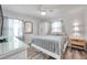 Cozy bedroom with wood floors, complemented by natural light, a ceiling fan, a dresser and stylish mirror at 1117 Tyrone N Blvd, St Petersburg, FL 33710