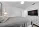 Well-lit bedroom features a large dresser and neutral decor, offering a serene and cozy space at 1117 Tyrone N Blvd, St Petersburg, FL 33710