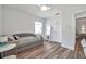Bedroom featuring light wood floors, modern fixtures, and a large mirror that maximizes light and space at 1117 Tyrone N Blvd, St Petersburg, FL 33710