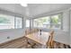 Bright dining area features a table with seating, large windows, and neutral colors, creating an inviting space at 1117 Tyrone N Blvd, St Petersburg, FL 33710
