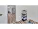 Neutral entryway featuring wood floors and storage rack for pet supplies; spacious interior view leads to main living area at 1117 Tyrone N Blvd, St Petersburg, FL 33710
