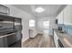 Galley kitchen featuring granite countertops and modern appliances with updated flooring at 1117 Tyrone N Blvd, St Petersburg, FL 33710