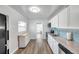 Bright kitchen featuring granite countertops, white cabinets, and modern appliances at 1117 Tyrone N Blvd, St Petersburg, FL 33710