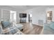 Spacious living room with hardwood floors, modern entertainment setup, and comfortable seating at 1117 Tyrone N Blvd, St Petersburg, FL 33710