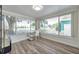 Bright sunroom featuring large windows and modern wood flooring for a warm aesthetic at 1117 Tyrone N Blvd, St Petersburg, FL 33710