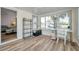 Bright sunroom with a view, shelving, and modern wood flooring at 1117 Tyrone N Blvd, St Petersburg, FL 33710