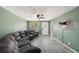 Inviting living room features a large sofa, ceiling fan, and a view to the exterior through a window at 11486 92Nd N St, Largo, FL 33773